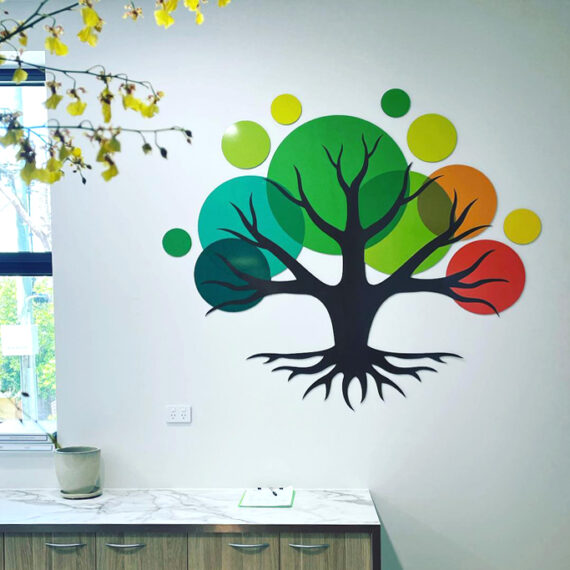 A tree shaped logo set on a wall above a coutner top